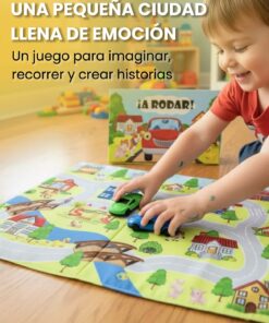 Niño pequeño jugando en el suelo sonriente mientras desplaza dos autitos de plástico sobre un tapiz ilustrado con calles y casas.